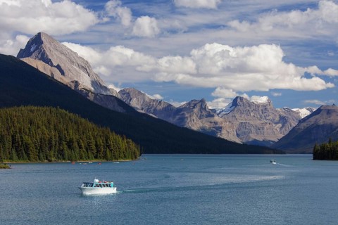 Canoes and tourist boat on Maligne Lake in Jasper National Park
