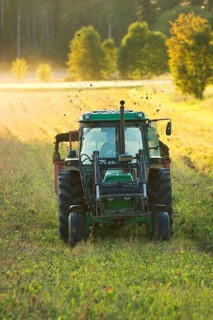 John Deere tractor pulling manure spreader