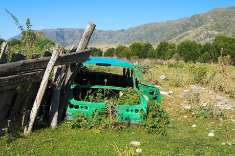 Old abandoned rusted car on a prairie