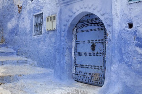 Blue door and stairs in an alley of the city