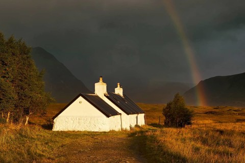 Blackrock hut at dawn with rainbow and gathering storm