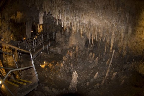 Steps and promenade through a cave with stalactites and stalagmites