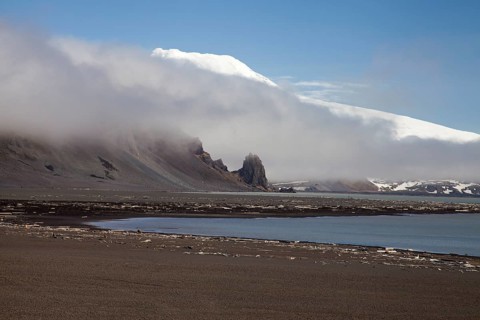 Black sandy beach and snow-covered volcano Beerenberg