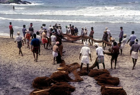 Fishermen hauling the fishing nets in Kovalam beach near Thiruvananthapuram