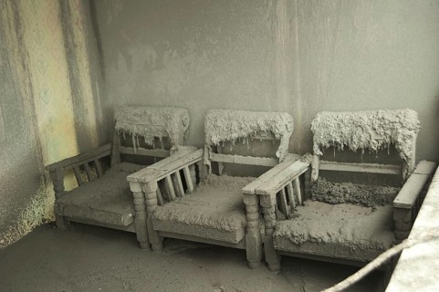 Ash-covered chairs in a house damaged by the recent volcanic eruption
