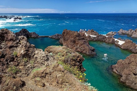 Tourists bathe in natural lava pools