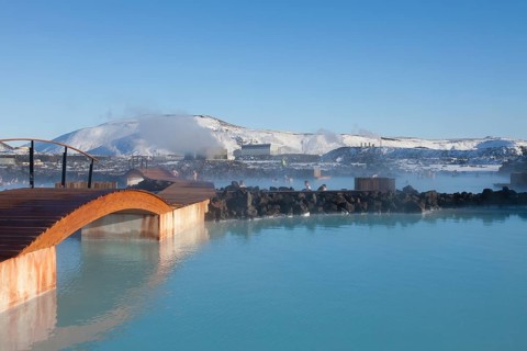 Tourists bathing in the blue lagoon rich in minerals such as silica and sulphur in a lava field in winter
