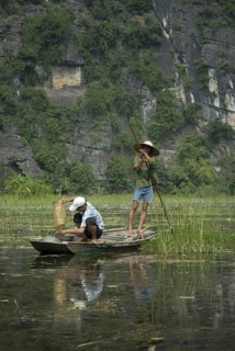 Men fishing from a boat on the waterway