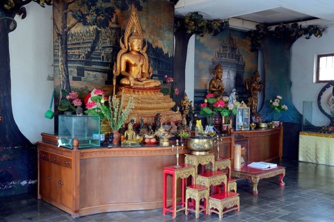 Buddha statue on an altar in a prayer room of the Buddhist monastery Brahma Vihara