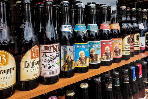 Belgian beers for sale in the window of a liquor shop in Belgium