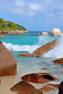 Beach and rocks of Anse Lazio in the evening