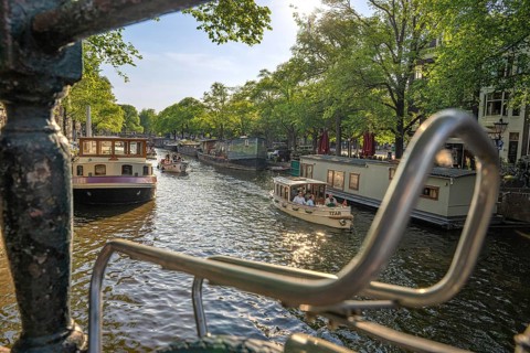 Over a bicycle carrier on the canal to a tourist boat