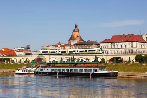 Landsberg an der Warthe town on the river with a Newag Impuls 2 regional train in Gorzow Wielkopolski