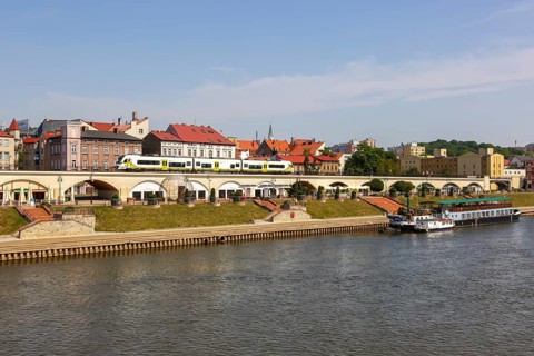 Landsberg an der Warthe town on the river with a Newag Impuls 2 regional train in Gorzow Wielkopolski