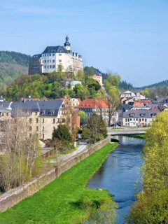 Town view with upper castle and river Weisse Elster