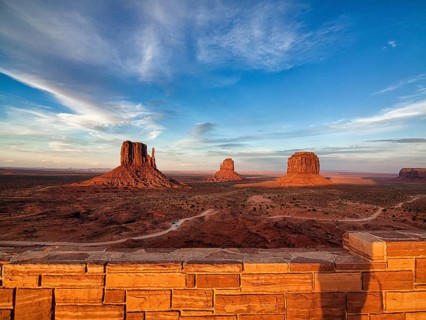 View of gravel road and mesas at sunset from the viewing platform