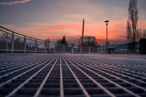 Grid floor of a viewing platform on the banks of the En River at sunset