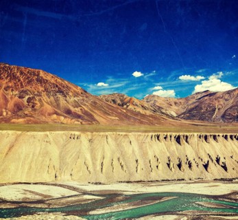Vintage retro effect filtered hipster style travel image of Himalayan landscape in Hiamalayas near Baralacha La pass with grunge texture overlaid. Himachal Pradesh