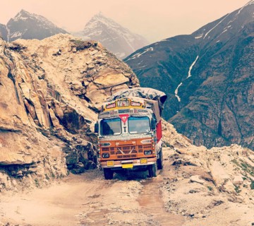 Vintage retro effect filtered hipster style travel image of Manali-Leh road in Indian Himalayas with lorry. Himachal Pradesh