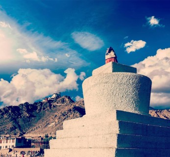 Vintage retro effect filtered hipster style travel image of Whitewashed chorten and Tsemo fort and gompa. Leh
