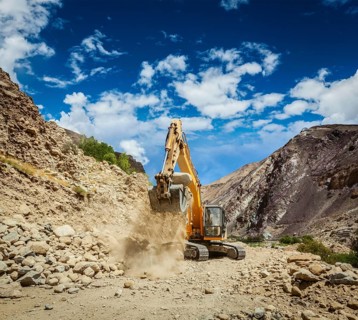 Excavator doing road construction in Himalayas. Ladakh