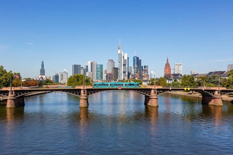 Skyline with river Main and light rail on Ignatz Bubis bridge Travel in Frankfurt