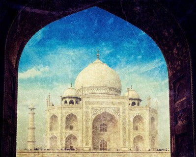 Vintage retro hipster style travel image of Taj Mahal through arch