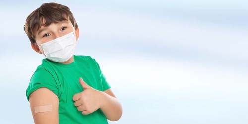 Child Boy With Plaster Inoculating Children Mask Showing Thumbs Up Against Coronavirus Corona Virus copy space Copyspace in Stuttgart