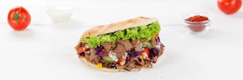 Doener Kebab Doner Kebap fast food in pita bread on wooden board Panorama in Stuttgart