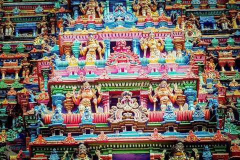 Vintage retro hipster style travel image of Sculptures on Hindu temple gopura