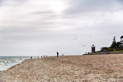 Strollers on the south beach in autumn