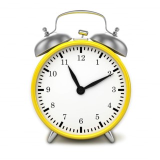 Yellow retro styled classic alarm clock isolated on white