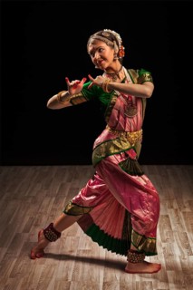Young beautiful woman dancer exponent of Indian classical dance Bharatanatyam in Krishna pose