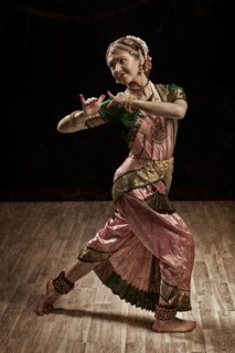 Vintage retro style image of young beautiful woman dancer exponent of Indian classical dance Bharatanatyam in Krishna pose