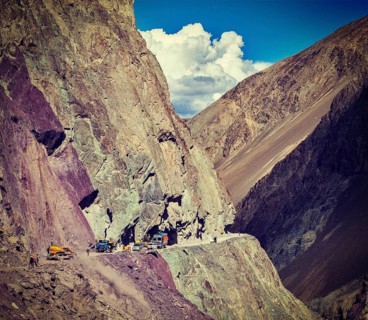 Vintage retro effect filtered hipster style travel image of Road construction in Himalayas. Ladakh