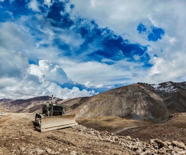 Bulldozer on road in Himalayas. Ladakh