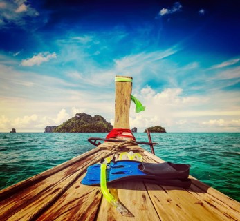 Vintage retro effect filtered hipster style travel image of snorkeling set on boat