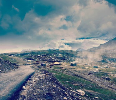 Vintage retro effect filtered hipster style travel image of Road in Himalayas on top of Rohtang La pass