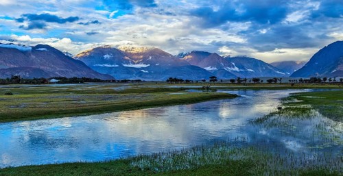 Panorama of Himalayas and landscape of Nubra valley on sunset. Hunber