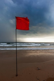 Severe storm warning flags on beach. Baga