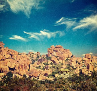 Vintage retro hipster style travel image of Ancient ruins of Hampi. Karnataka