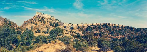 Vintage retro hipster style travel image of panorama of Kumbhalgrh fort. Rajasthan