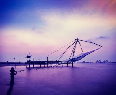 Vintage retro hipster style travel image of Kochi chinese fishnets on sunset. Fort Kochin
