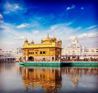 Vintage retro hipster style travel image of famous India attraction Sikh gurdwara Golden Temple