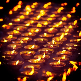 Vintage retro effect filtered hipster style travel image of burning candles in Buddhist temple. Tsuglagkhang complex
