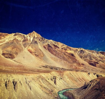 Vintage retro effect filtered hipster style travel image of Himalayan landscape in Hiamalayas near Baralacha La pass with grunge texture overlaid. Himachal Pradesh