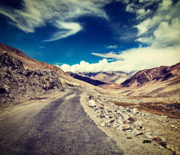 Vintage retro effect filtered hipster style travel image of Scenic road in Himalayas near Khardung-La pass. Ladakh