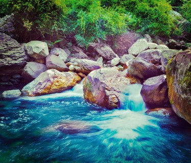 Vintage retro effect filtered hipster style travel image of small waterfall