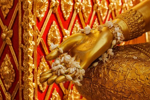 Buddha statue hand with flowers. Wat Phra That Doi Suthep