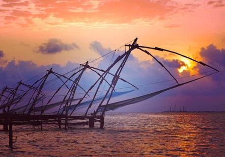 Vintage retro hipster style travel image of Kochi chinese fishnets on sunset with grunge texture overlaid. Fort Kochin